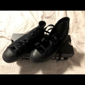 Black converse high tops .